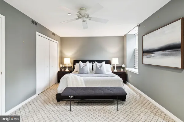 a bedroom with a bed and a mirror