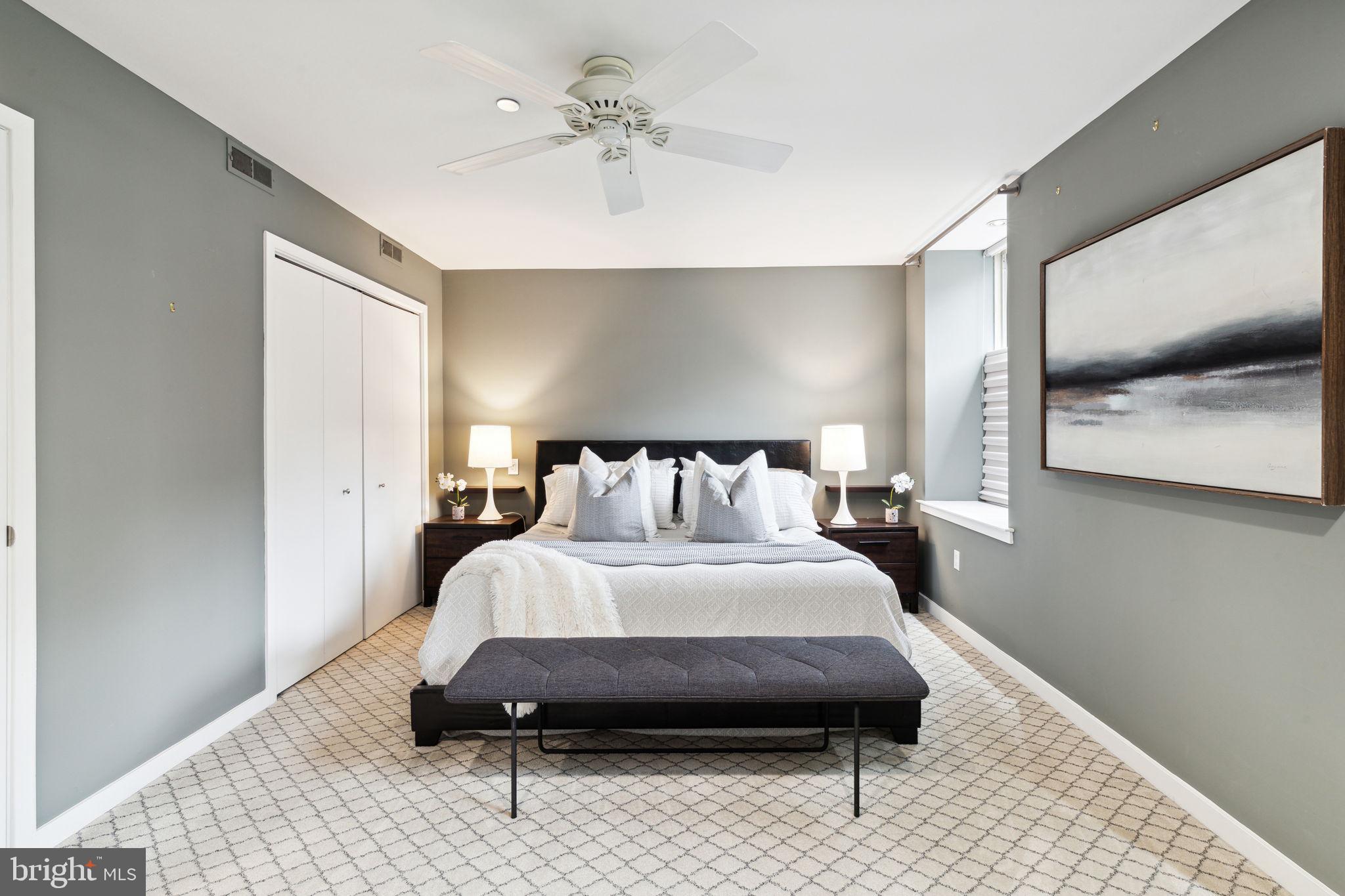 1737 Chestnut Street, Unit 501 Philadelphia, PA 19103 - Photo 15 of 27 a bedroom with a bed and a mirror