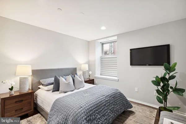 a bedroom with a bed and a flat screen tv