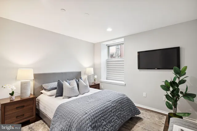 a bedroom with a bed and a flat screen tv