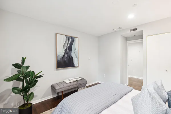 a bedroom with a bed and a plant