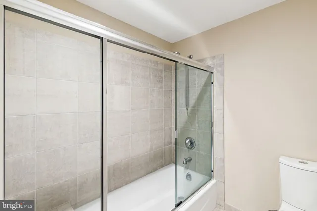 a bathroom with a glass shower door