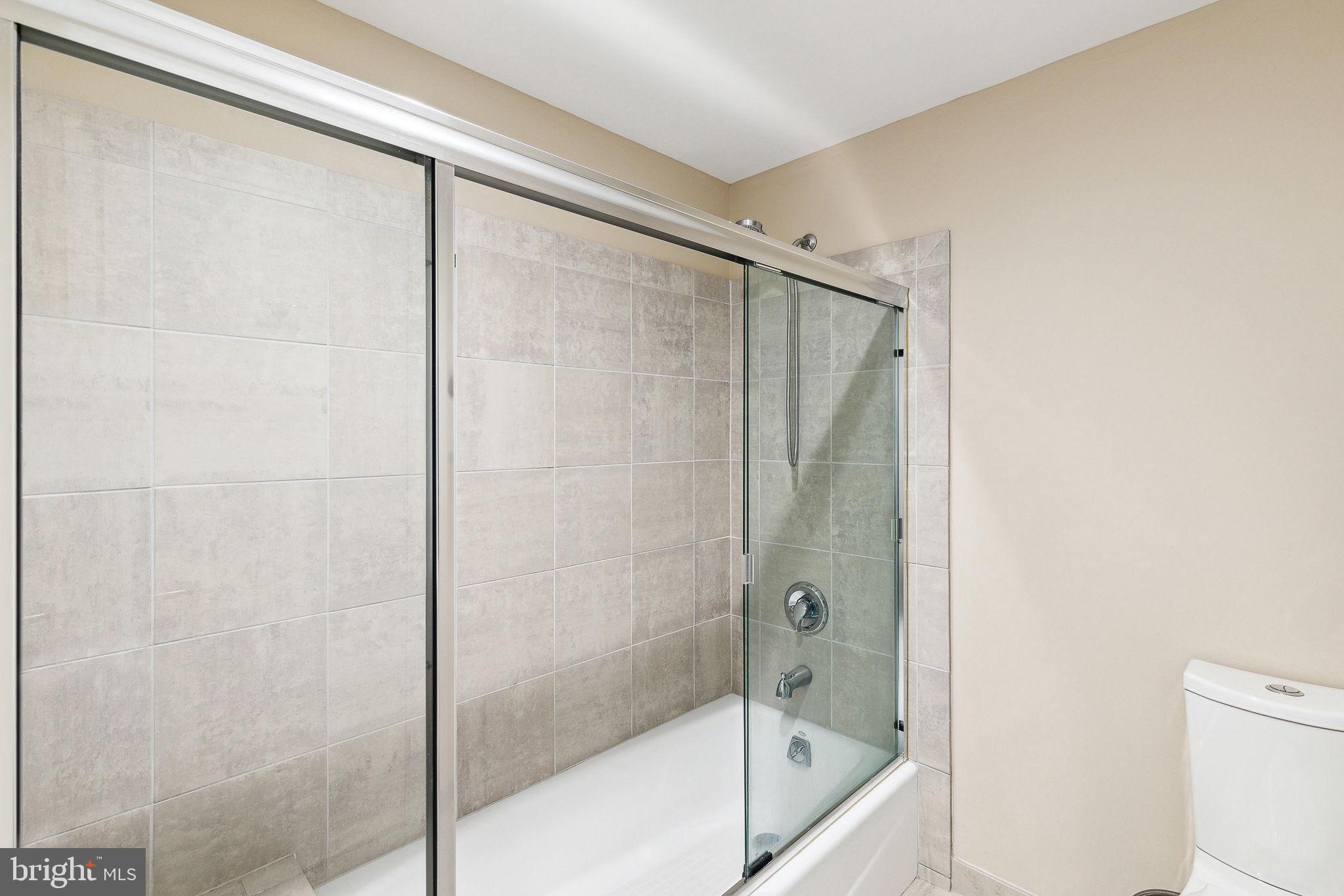 1737 Chestnut Street, Unit 501 Philadelphia, PA 19103 - Photo 24 of 27 a bathroom with a glass shower door