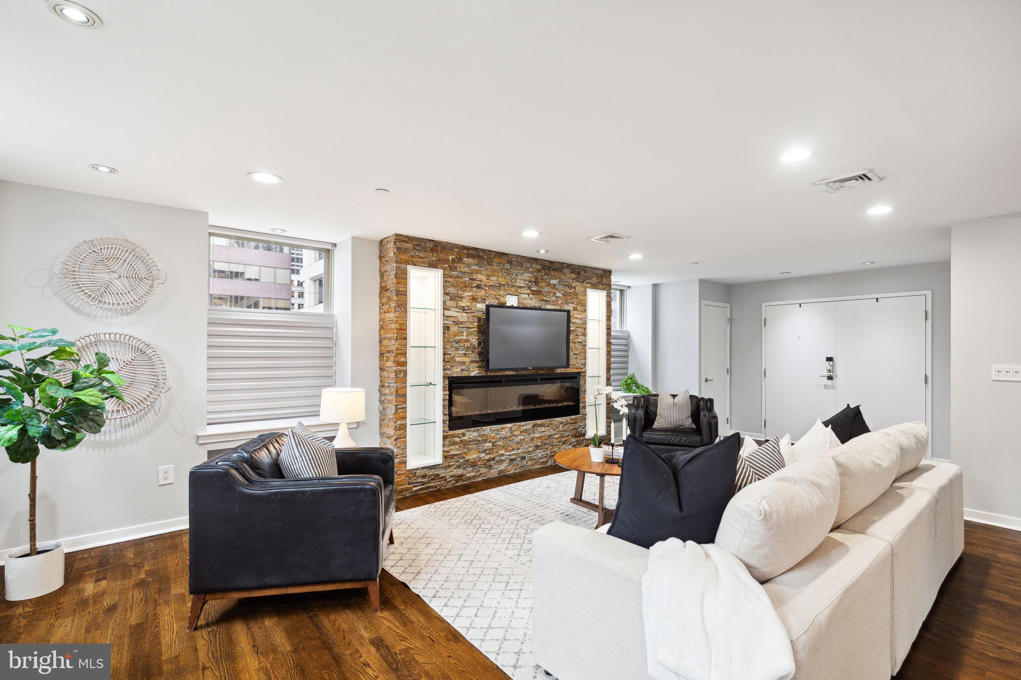 1737 Chestnut Street, Unit 501 Philadelphia, PA 19103 - Photo 3 of 27 a living room with furniture and a flat screen tv