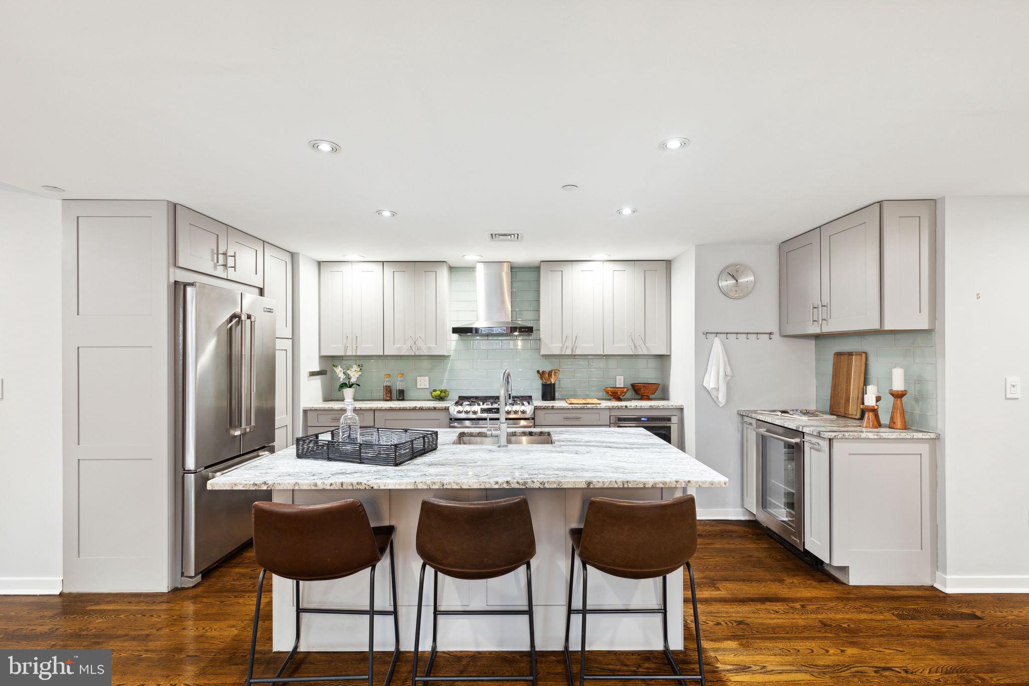 1737 Chestnut Street, Unit 501 Philadelphia, PA 19103 - Photo 9 of 27 a kitchen with stainless steel appliances granite countertop a table and chairs in it