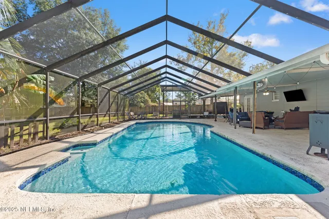 a view of a swimming pool with a patio