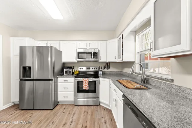 a kitchen with a refrigerator stove and sink