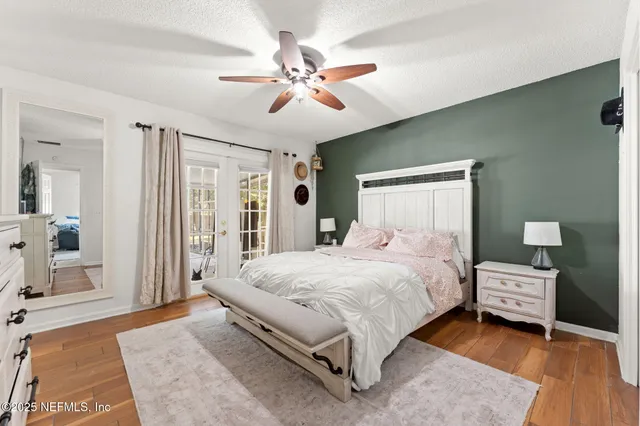 a bedroom with a bed and a chandelier