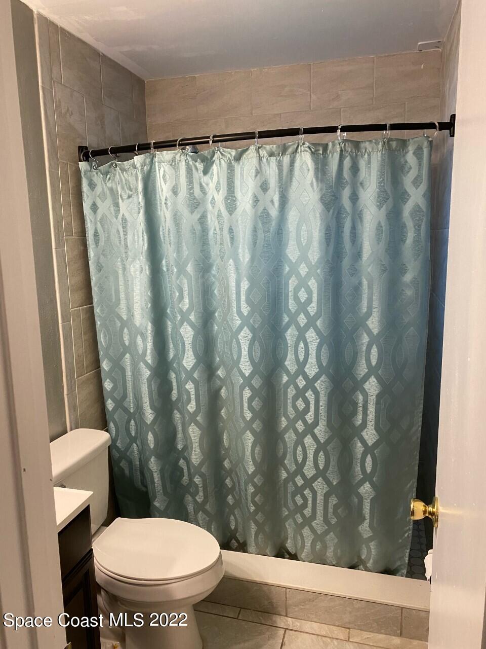 658 Waycross Road Southwest Palm Bay, FL 32908 - Photo 13 of 39 a white toilet sitting next to a shower
