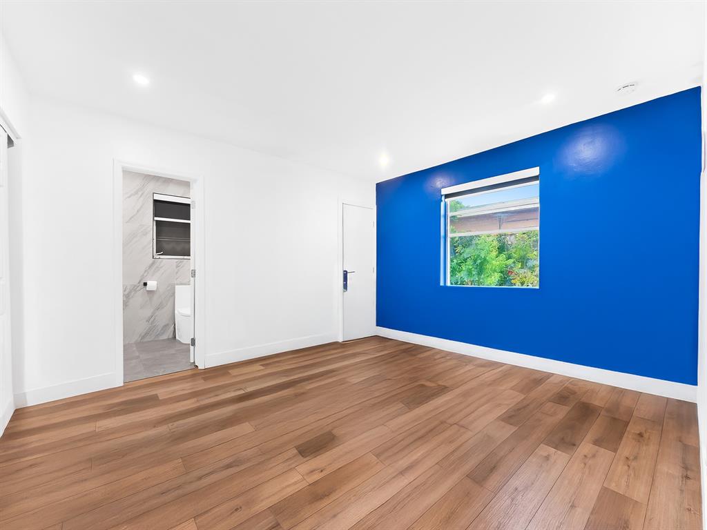 4411 Thomas Street Hollywood, FL 33021 - Photo 13 of 21 a view of an empty room with wooden floor and a window