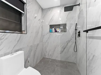 a bathroom with a toilet sink and shower