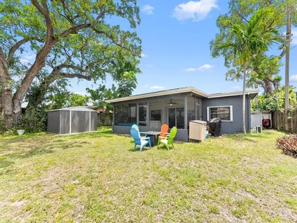 a front view of house with yard and trees in the background
