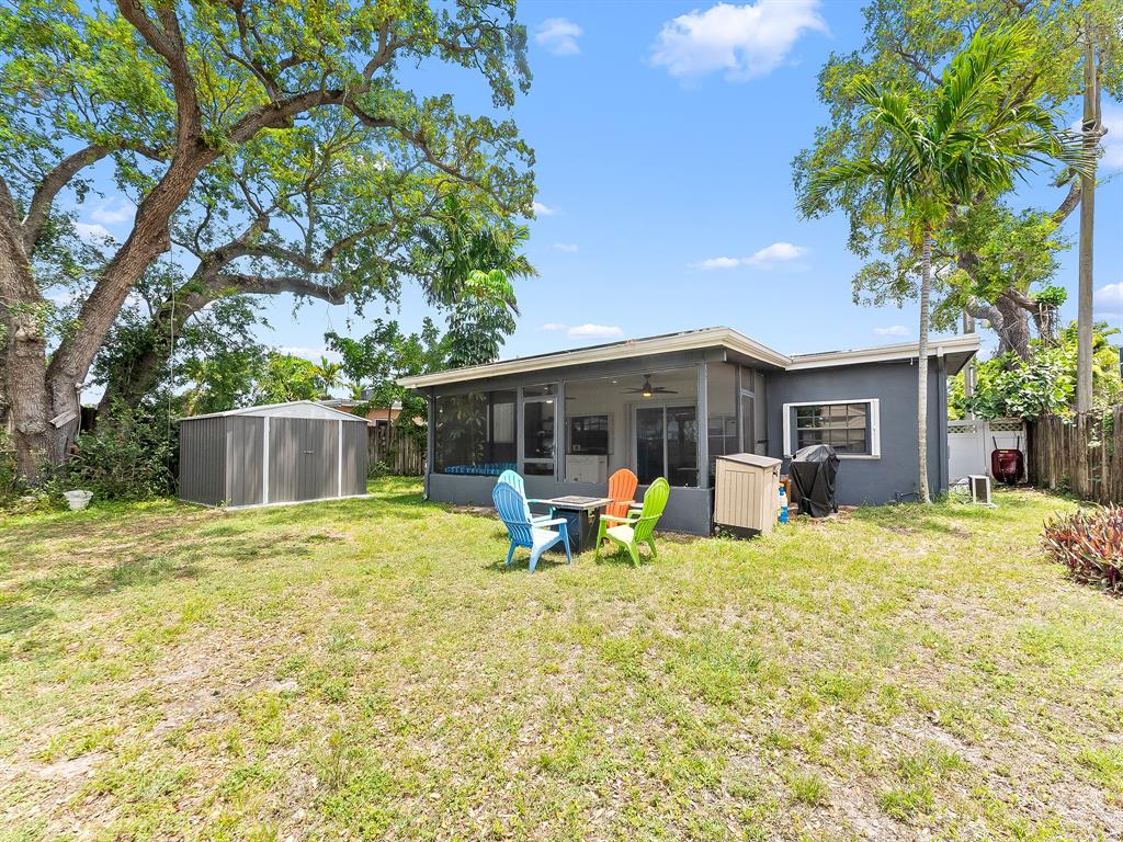 4411 Thomas Street Hollywood, FL 33021 - Photo 19 of 21 a front view of house with yard and trees in the background