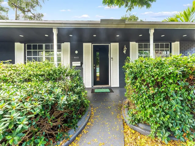 a front view of a house with a lots of yellow lighting