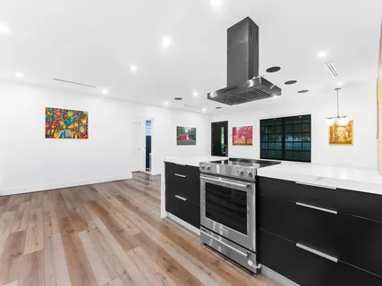 a kitchen with stainless steel appliances granite countertop a stove and a sink