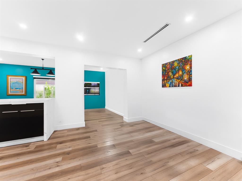 4411 Thomas Street Hollywood, FL 33021 - Photo 10 of 21 a view of an empty room with wooden floor and kitchen