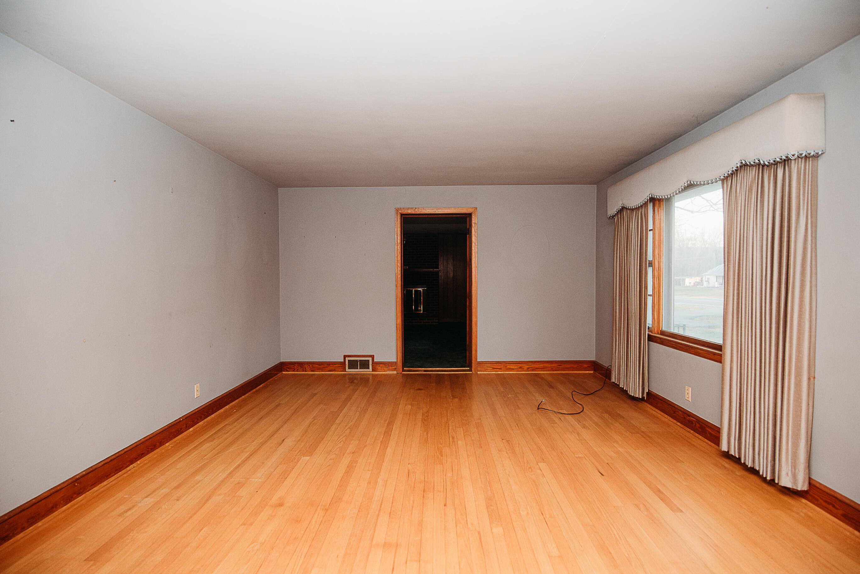 925 Scuffling Hill Road Rocky Mount, VA 24151 - Photo 8 of 12 wooden floor in an empty room with a window