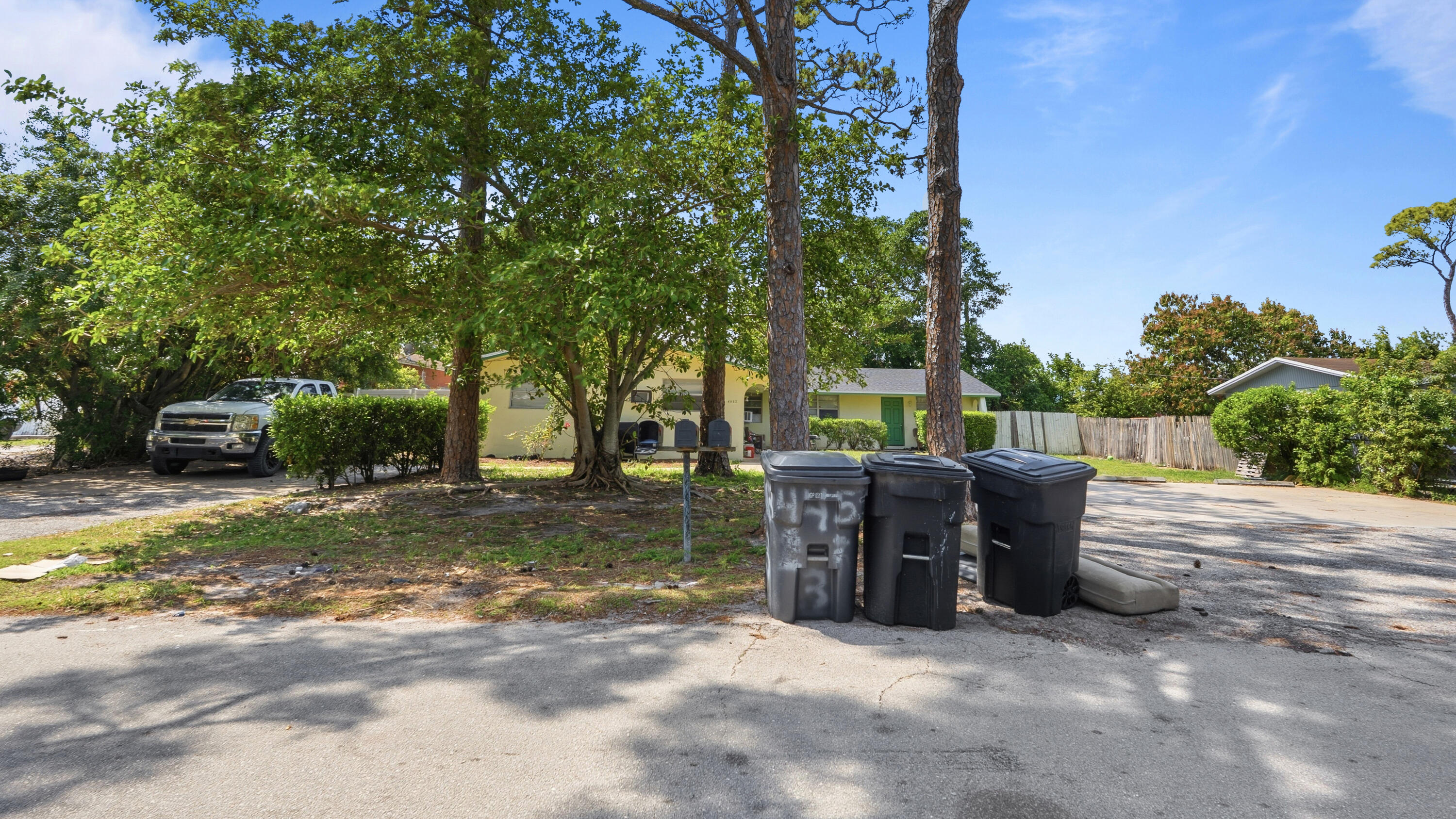 4453 Stevens Road Lake Worth Beach, FL 33461 - Photo 23 of 67 a view of a patio with a table and chairs under an umbrella