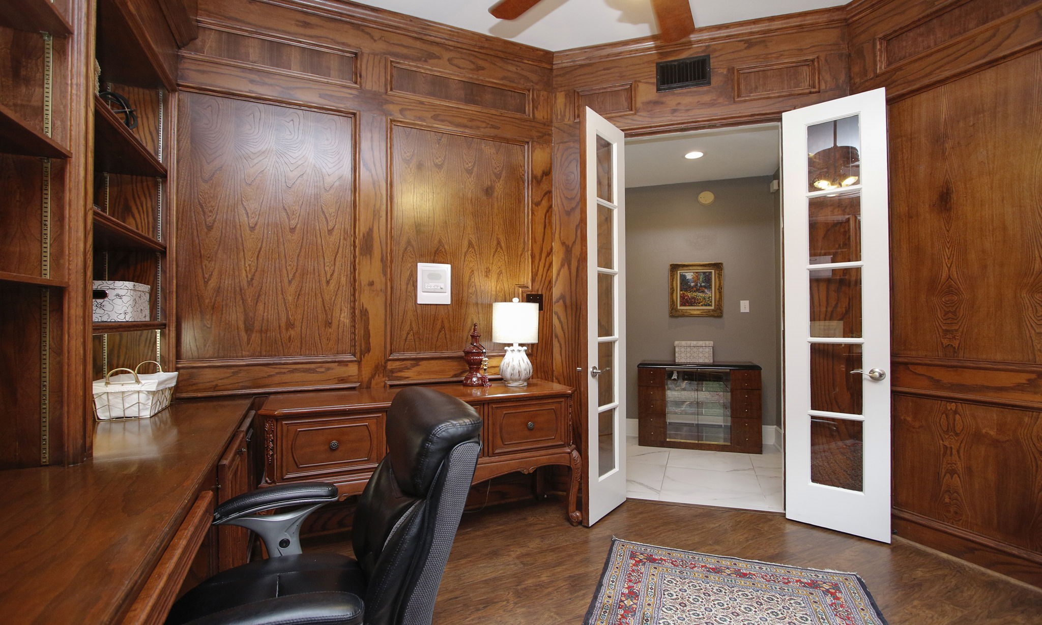 16610 Manningtree Lane Spring, TX 77379 - Photo 31 of 50 The rich wood paneled office is located off the foyer and down a hallway; a great space for quiet work and conference calls.