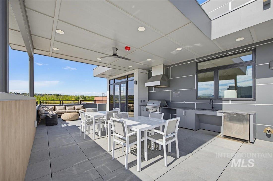4184 East Haystack Street, Unit 103 Boise, ID 83716 - Photo 17 of 27 Expansive outdoor terrace featuring a built-in outdoor kitchen with grill and sink, recessed lighting, ceiling fan, and large format tile flooring