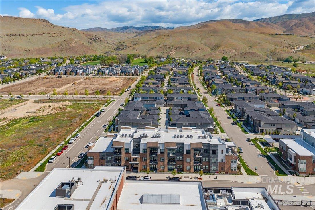 4184 East Haystack Street, Unit 103 Boise, ID 83716 - Photo 27 of 27 Modern apartment building featuring a brick and panel facade, multiple balconies, and a flat roofline