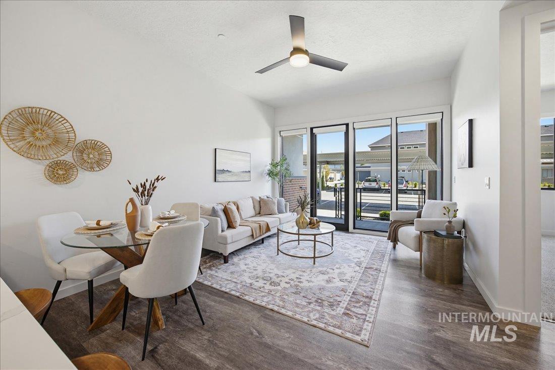 4184 East Haystack Street, Unit 103 Boise, ID 83716 - Photo 7 of 27 Open-concept living area with wood-finish flooring, a contemporary ceiling fan, and large glass patio doors