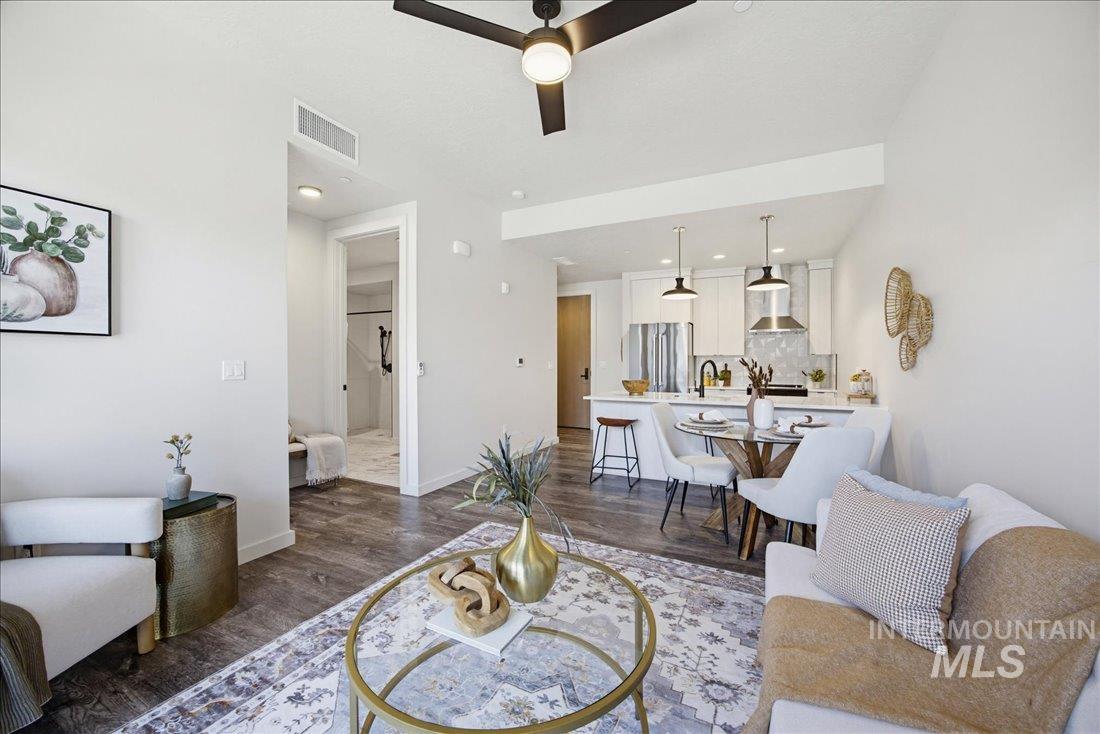 4184 East Haystack Street, Unit 103 Boise, ID 83716 - Photo 8 of 27 Open-concept living space featuring wood-finish flooring, a modern ceiling fan, recessed lighting, and a kitchen with stainless steel appliances