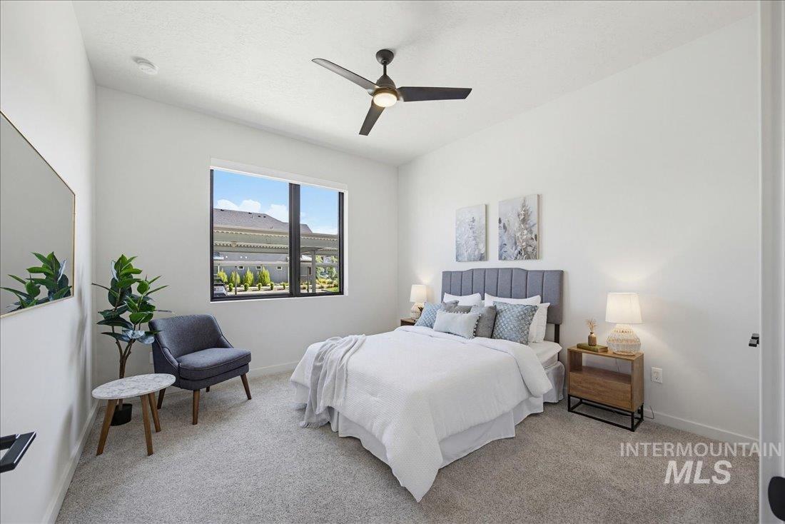 4184 East Haystack Street, Unit 103 Boise, ID 83716 - Photo 9 of 27 Bright interior space featuring a ceiling fan, large window, and light-colored carpeting