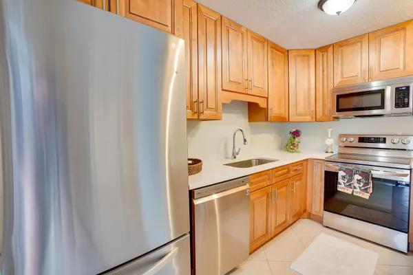 a kitchen with a sink cabinets and a window