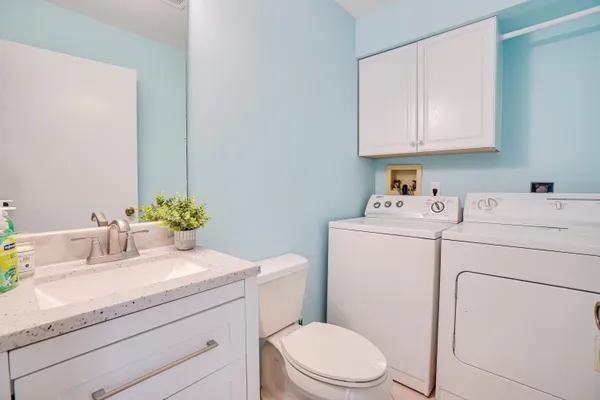 a bathroom with a sink toilet vanity and tub