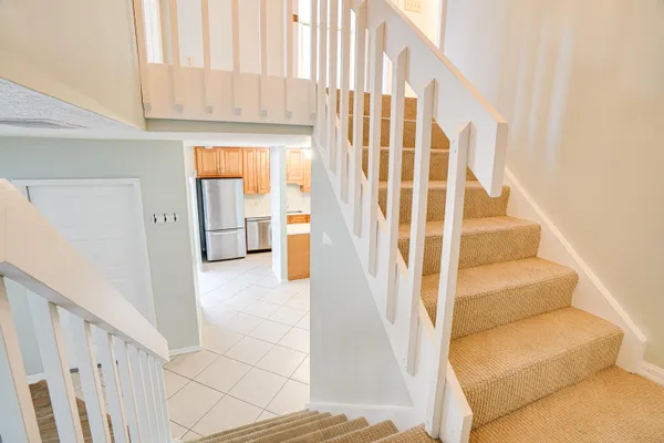 a view of staircase with white walls and a window