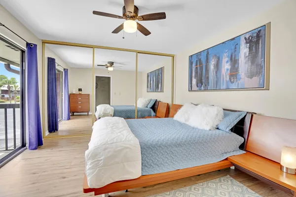 a bed room with a bed and painting on the wall