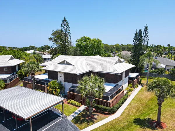 an aerial view of a house with swimming pool garden and patio