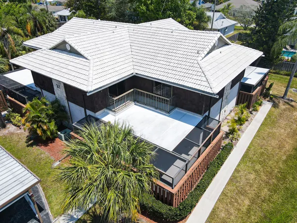 an aerial view of a house with a yard and balcony