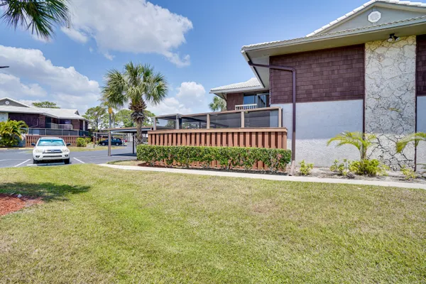 a view of a house with a yard and sitting area