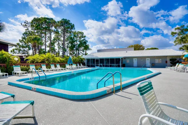 a view of house with swimming pool outdoor seating