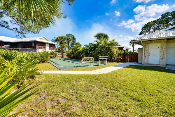 a house view with swimming pool in front of it