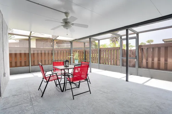 a dining room with furniture and a floor to ceiling window