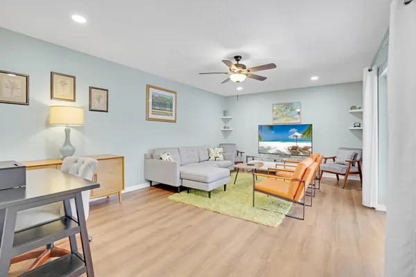 a living room with furniture and a wooden floor
