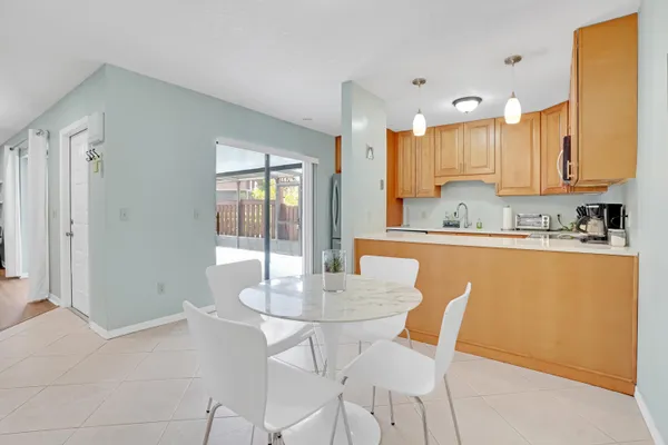 a dining room with furniture a window and kitchen view
