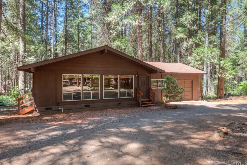 Absolutely wonderful mountain retreat. Home situated on a one beautiful acre of land, surrounded by large majestic trees. 2 Bedroom home with bonus room. High vaulted wood ceilings in Living, Dining and Kitchen. Cozy gas freestanding stove in living room. Laminate flooring in Kitchen and hallway, Newer dual pane windows in most rooms. Large circle drive with unlimited parking area including plenty of room for RV/Boat or any parking needs. Original family owned home. Home tucked away, on a flag lot off Fair