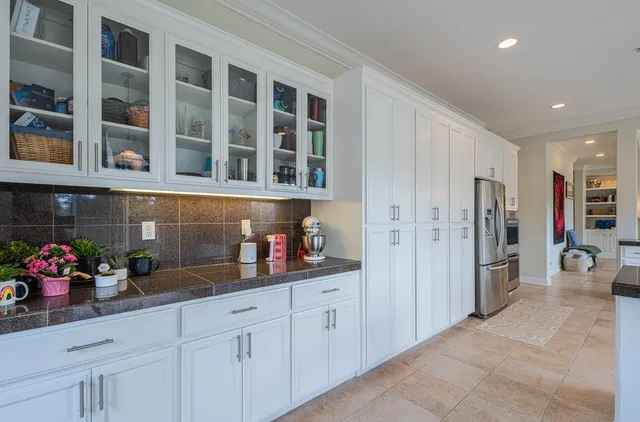 a living room with furniture and a dining table with wooden floor