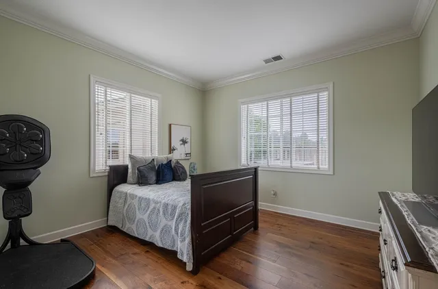 a view of a hallway with wooden floor and stairs