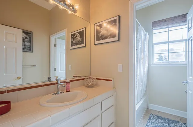 a living room with furniture a flat screen tv and a large window