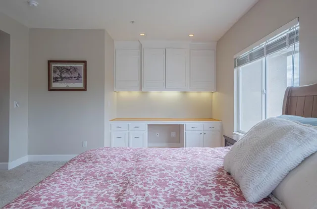 an empty room with wooden floor and a ceiling fan