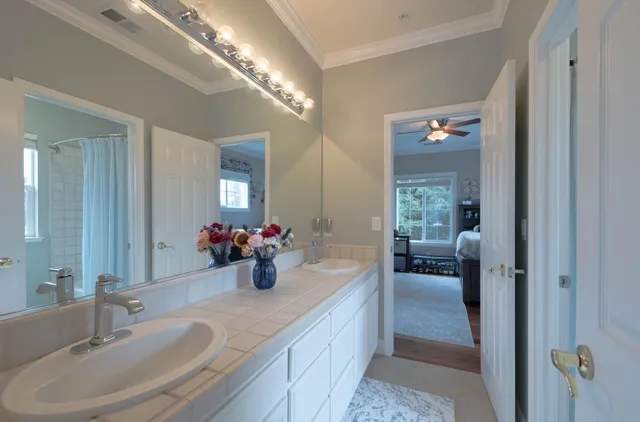 a view of a backyard with table and chairs and wooden fence