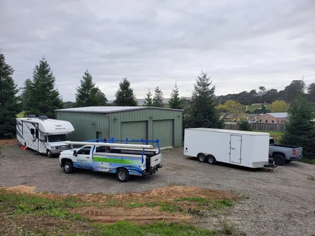a front view of a house with a garden and trees