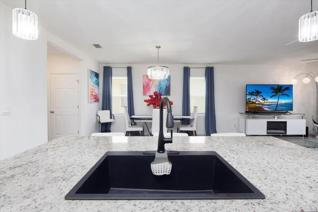 a kitchen with sink and refrigerator