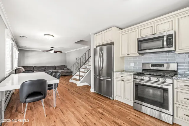 a kitchen with stainless steel appliances a stove a microwave and a refrigerator