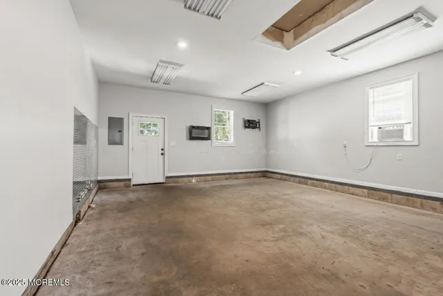 an empty room with a empty space and windows